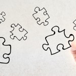 Businessman drawing puzzle piece sketch