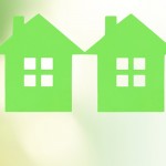 man and woman hands with many green paper houses