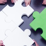 business team solving puzzle